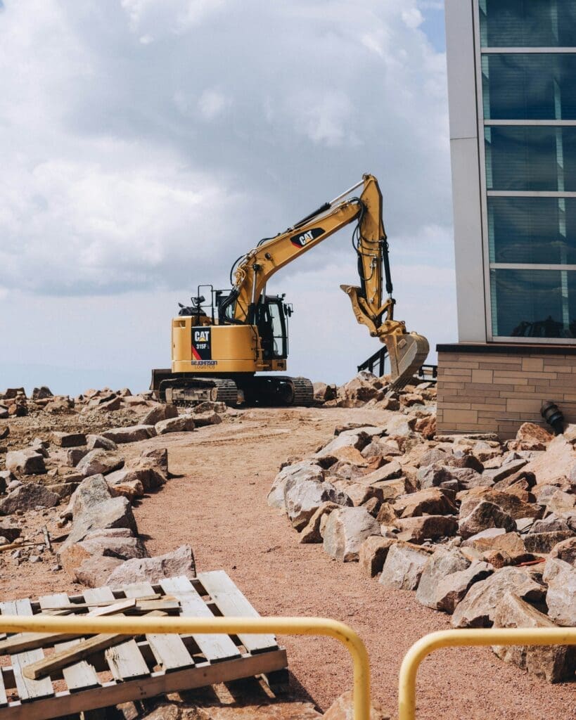Commercial excavator digging as part of excavating solutions